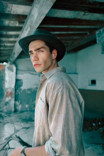 Man Wearing Beige Top and Black Hat