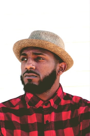 Man Wearing Black and Red Plaid Top and Beige Hat