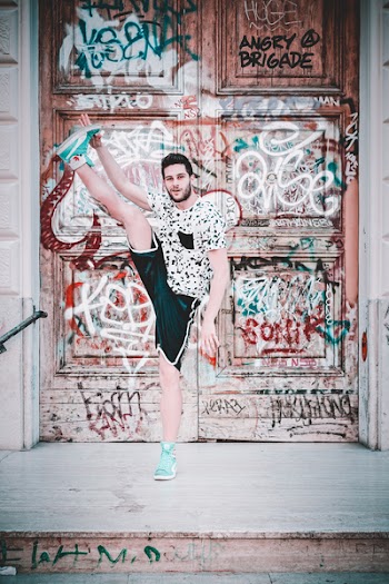 Man Wearing Black And White Crew-neck T-shirt With Foot Up