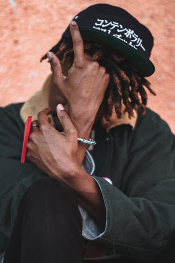 Man Wearing Black and White Fitted Cap