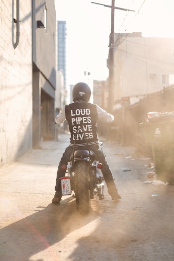 Man Wearing Black and White Jacket Riding on Motorcycke