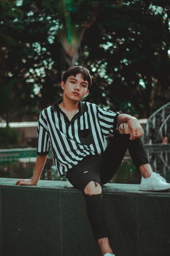 Man Wearing Black and White Striped Polo Shirt