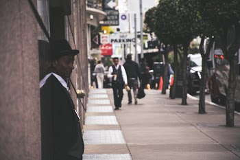 Man Wearing Black Blazer Beside Building
