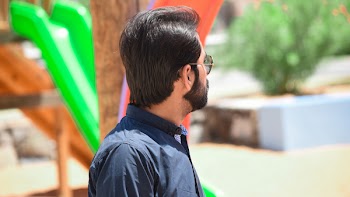 Man Wearing Black Button-up Shirt Standing Near Green and Brown Slide