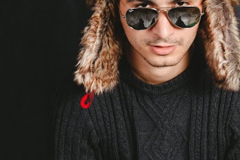 Man Wearing Black Cable-knit Crew-neck Sweater While Taking a Photo
