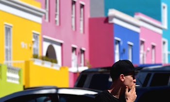 man wearing black cap smoking