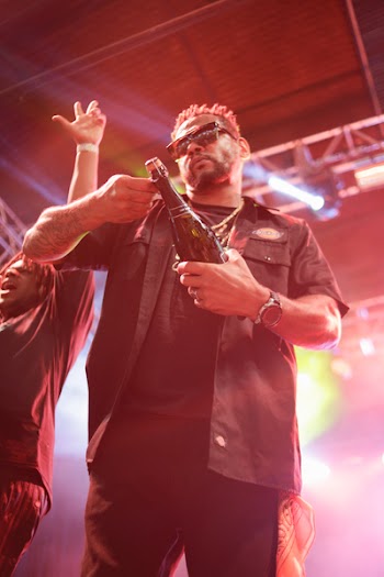 Man Wearing Black Collared Top Holding Bottle