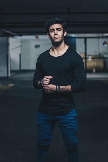 man wearing black crew-neck long-sleeved t-shirt