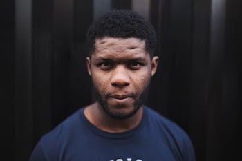 man wearing black crew-neck shirt