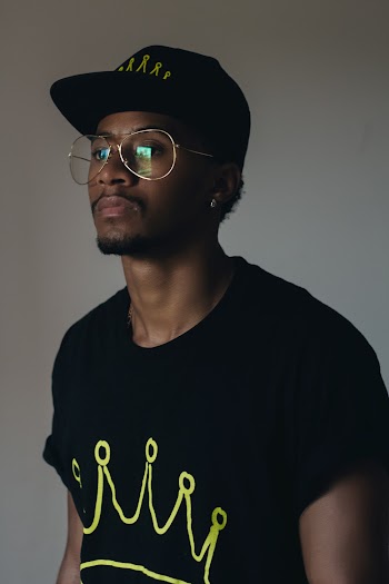 Man Wearing Black Crew-neck Shirt and Black Cap