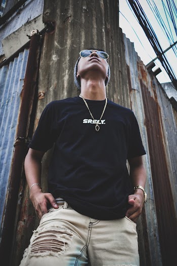 Man Wearing Black Crew-neck Shirt and Blue Faded Denim Bottoms