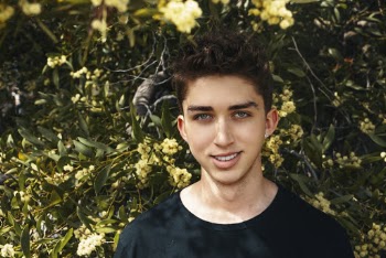 Man Wearing Black Crew-neck Shirt Beside Yellow Petaled Flower