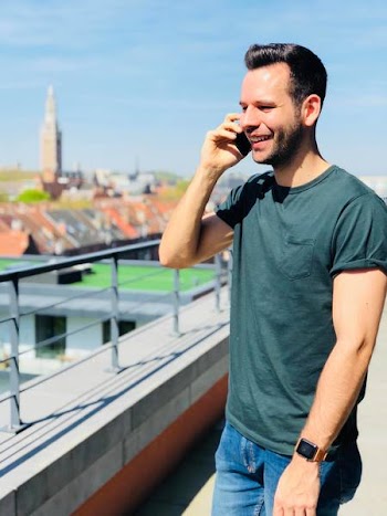 Man Wearing Black Crew-neck Shirt Holding Mobile Phone