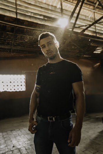 Man Wearing Black Crew-neck Shirt With His Right Hands on Pocket