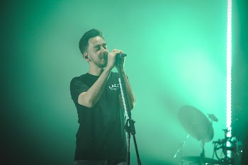 Man Wearing Black Crew-neck T-shirt Holding Microphone