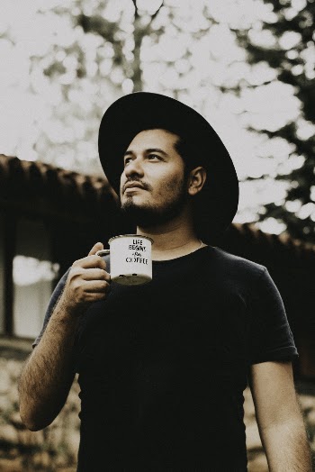 Man Wearing Black Crew-neck T-shirt Holding Mug
