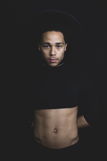 Man Wearing Black Crop Top With Black Background