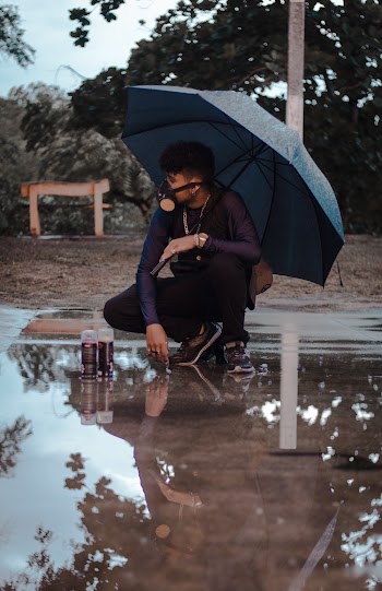 Man Wearing Black Dress Shirt and Pants and Blue Umbrella
