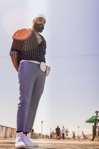 Man Wearing Black Dress Shirt and Purple Pants Standing on Street