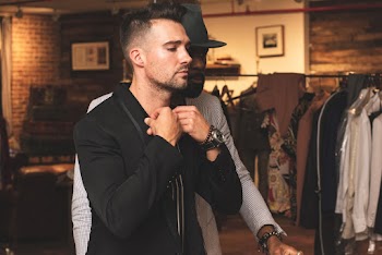 Man Wearing Black Dress Shirt Besides Man Wearing Black Hat