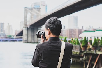 Man Wearing Black Dress Shirt Using Dslr Camera