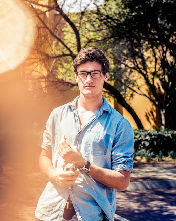 Man Wearing Black Eyeglasses and Blue Denim Button-up Elbow-sleeved Shirt