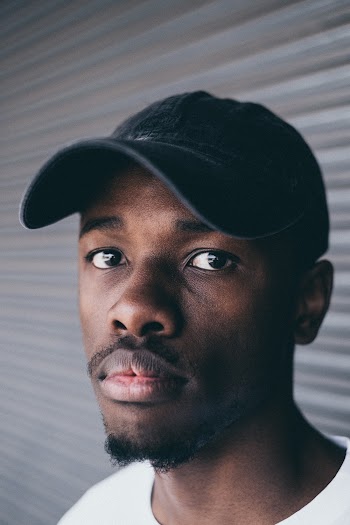 Man Wearing Black Fitted Cap