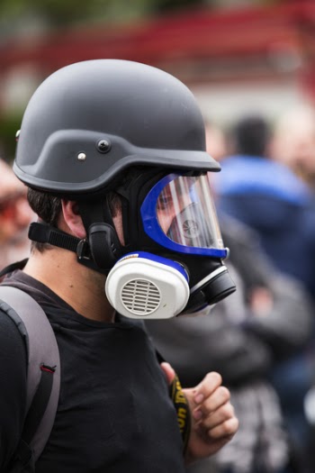 Man Wearing Black Gas Mask and Protective Helmet