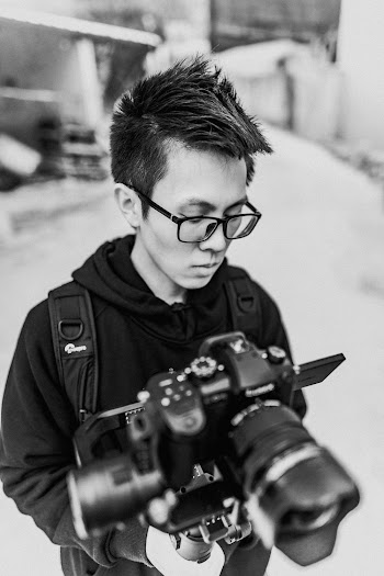 Man Wearing Black Jacket Holding Black Dslr Camera