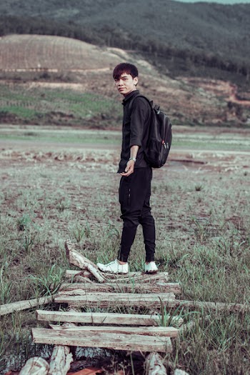 Man Wearing Black Jogger Pants and Backpack
