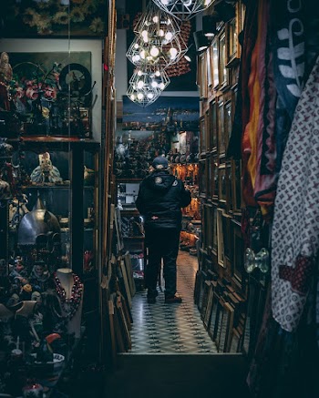 Man Wearing Black Leather Jacket Standing Inside A Store