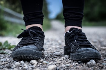 Man Wearing Black Low-top Sneakers Standing on Ground