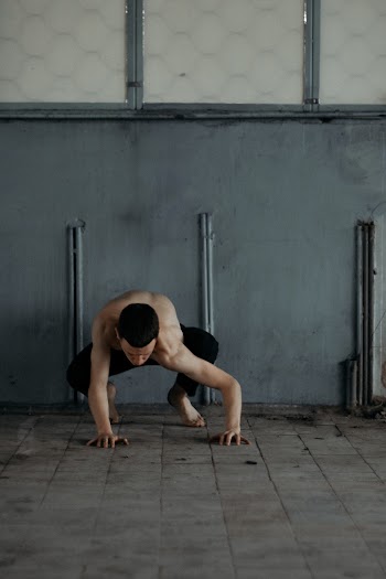 Man Wearing Black Pants Beside Wall