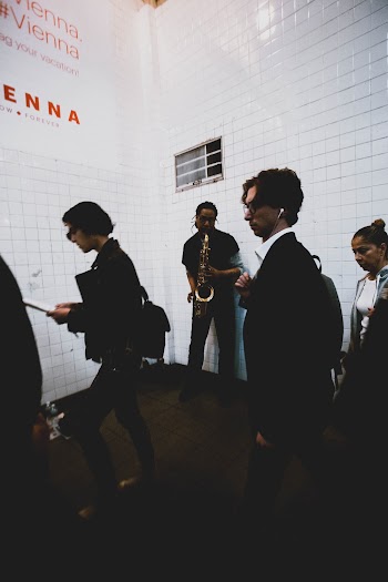 Man Wearing Black Pants Playing Saxophone