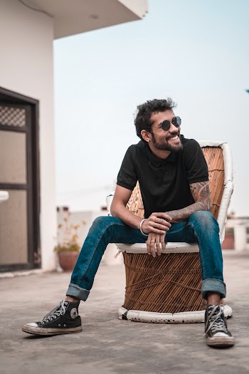 Man Wearing Black Polo Shirt and Blue Faded Jeans