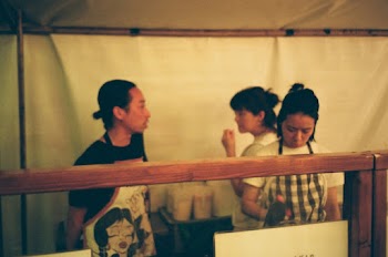 Man Wearing Black Shirt and White Apron With Print