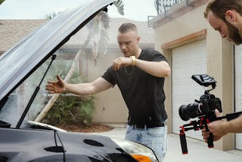 Man Wearing Black Shirt Looking at Car Engine Bay