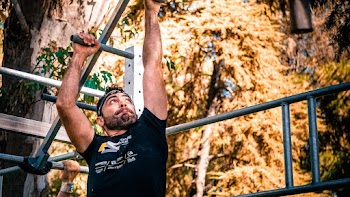 Man Wearing Black Shirt on Monkey Bar