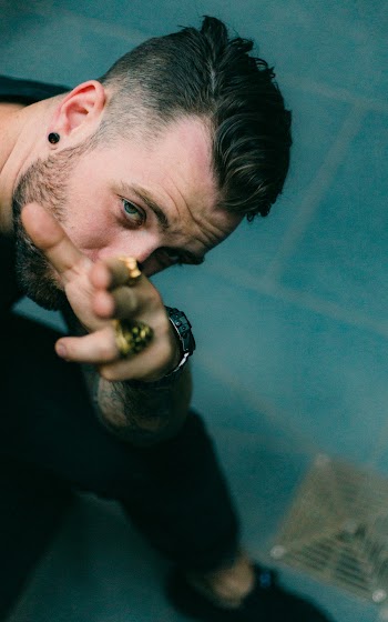 Man Wearing Black Shirt Pointing Towards the Camera