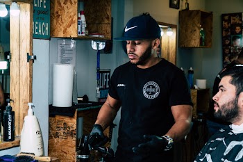 Man Wearing Black Shirt Standing Near Man Wearing Gray Shirt Inside Room