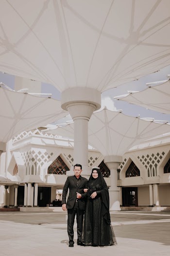 Man Wearing Black Shirt Standing Near Woman Wearing Black Hijab