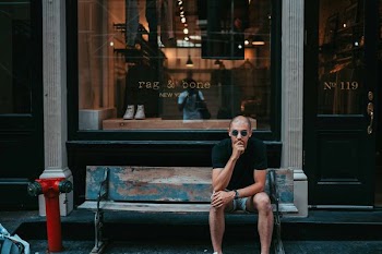 man wearing black shirt while sitting