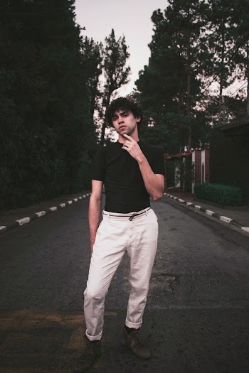 Man Wearing Black Short Sleeved Shirt And White Pants Standing 