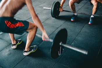 Man Wearing Black Shorts Lifting Heavy Barbells