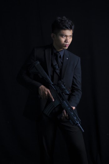 Man Wearing Black Suit and Carrying M4 Carbine With Scope