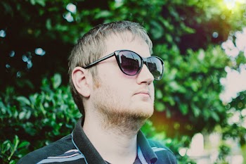 Man Wearing Black Sunglasses and Polo Shirt