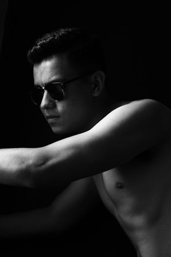 man wearing black sunglasses leaning
