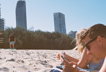 Man Wearing Black Sunglasses Using Smartphone