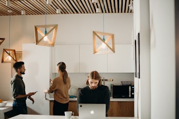 Man Wearing Black Sweater Using Silver Macbook