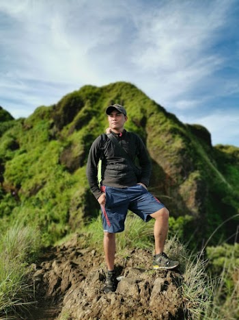 Man Wearing Black Sweatshirt Standing on Cliff